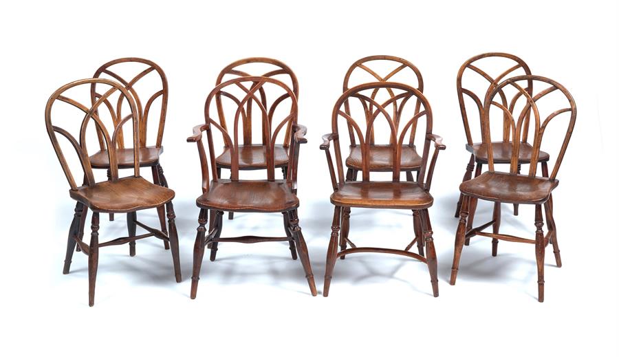 A matched set of eight George IV ash, elm and beech Gothic Windsor chairs, Buckinghamshire