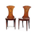 A pair of Regency mahogany hall chairs