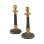 A pair of 19th century French Empire patinated bronze and gilt bronze candlesticks