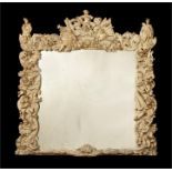 A late 17th century carved giltwood 'trophy' frame with a later mirror plate