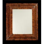A William & Mary olivewood oyster-veneered cushion frame mirror