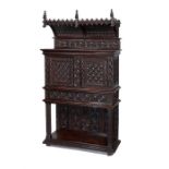 A late 19th century Gothic style carved oak canopy cupboard