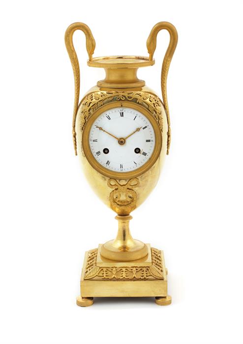 An Empire gilt-bronze clock in the form of a classical twin-handled vase