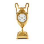 An Empire gilt-bronze clock in the form of a classical twin-handled vase