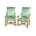 A pair of Louis XIV style carved giltwood fauteuils