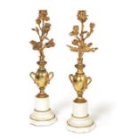 A pair of late 19th century French Louis XVI style gilt bronze and white marble candlesticks