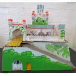 A wooden toy model of a castle, painted with decoration.