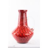 A Studio glass jug, red ground, 27cm high.