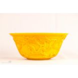 A yellow Chinese Peking glass bowl, carved with dragons chasing the pearl of wisdom with Qinlong