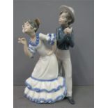 A Nao Lladro porcelain figure group; dancing boy and girl, no 565.