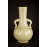 A celadon Chinese twin handled baluster vase, 24cm high.