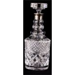 A cut glass decanter with silver collar, 29cm high.