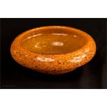 A 1970s Scottish Strathern glass bowl, with an orange flecked ground, 24cm diameter.