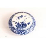A Chinese blue and white circular paste box of compressed circular form, 9cm diameter, 3cm high.