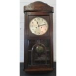 A 1950s oak cased wall clock with arabic dial.