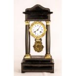 An ebonised mantle clock with gilt brass pendulum.