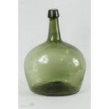 A 19th century green glass bottle of globular form.