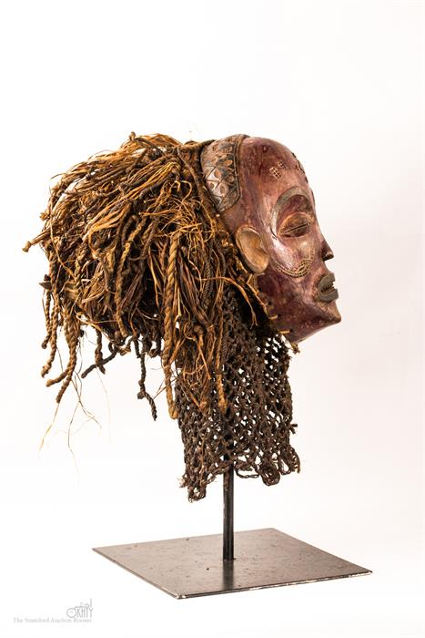 A Chokwe tribal mask, stained colour to the face, and raised on a bespoke metal stand. - Image 2 of 2