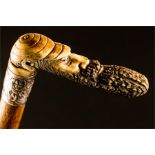 A walking cane circa 1900 with a handle carved in the form of cricketer W G Grace.