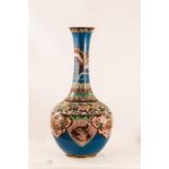 A Cloisonne vase, 48cm tall, depicting dragons and peonies.