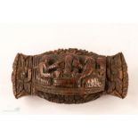 A 19th century coquilla nut snuff box, carved with figures and floral decoration.