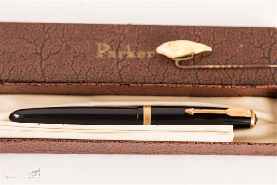A boxed Parker pen together with another Parker pen.