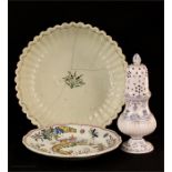 An early English bowl, a Delft style blue and white sifter and a polychrome plates.