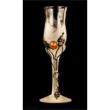 A frosted glass with silver and amber embellishment.