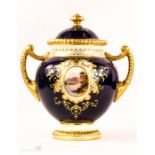 A Coalport porcelain twin handled jar & cover, with a cobalt blue ground, decorated with oval vistas