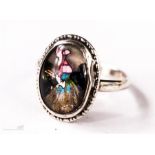 A silver and butterfly wing oval ring, depicting a lady with bonnet to the centre, size N, 3.0g.