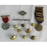 A group of military related buttons, medals, an RA