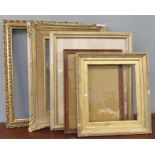 A group of picture frames of graduated size and va