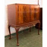A mahogany drinks cabinet, carved apron, mirrored back interior and glass top.