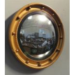 A Regency style port hole mirror.