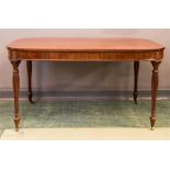 An early 19th century mahogany dining table, with fluted baluster legs, 69 by 136 by 98cm.