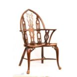 A Gothic style Windsor armchair, with arched back,