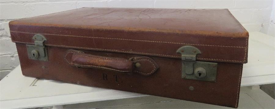 A leatherette suitcase, bearing initials RT.