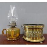 A Regency brass carriage warmer and a glass paraff