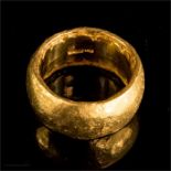 A 22ct gold ring, of hammered and brushed finish,