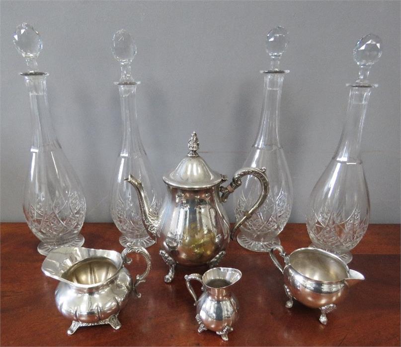 A group of four cut glass decanters, with footed b