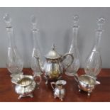 A group of four cut glass decanters, with footed b