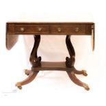 A 19th century mahogany sofa table circa 1820, cross banded and inlaid, two drawers to the front and