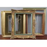 A group of five picture frames, one with green bor