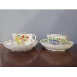 Two early pottery hand painted cups and saucers.