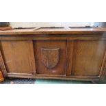 An oak blanket box with shield front.