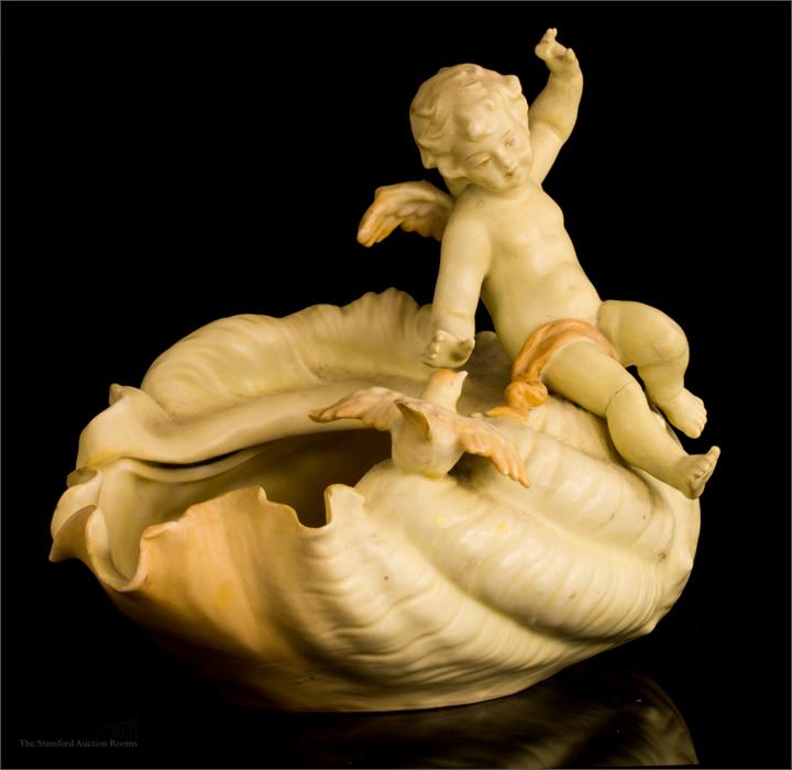 A Rudolstadt porcelain cherub and shell group.