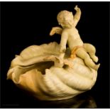 A Rudolstadt porcelain cherub and shell group.