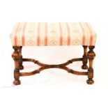 A William & Mary style stool, with wavy x-stretchers, upholstered seat and carved knop legs and