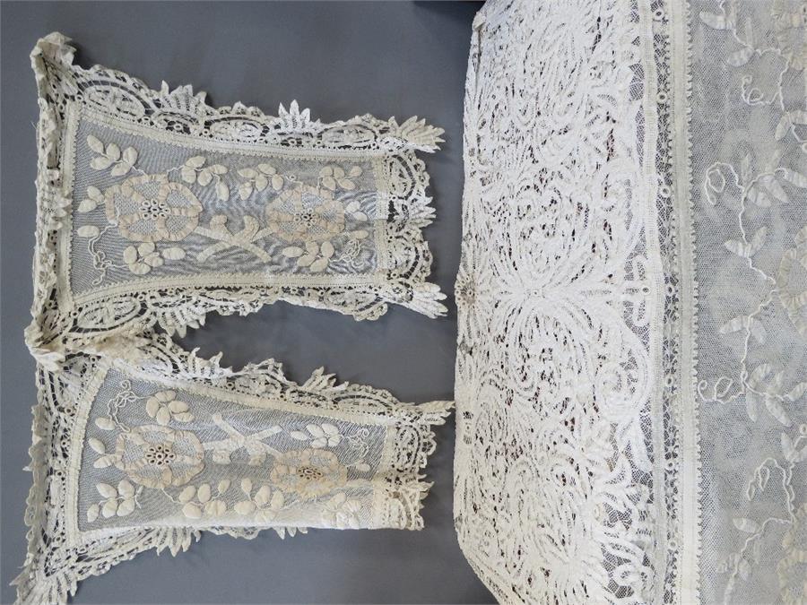 A handmade lace bedspread with matching pillow cov