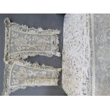 A handmade lace bedspread with matching pillow cov